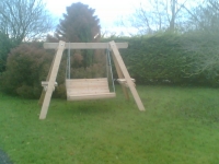 Custom built wooden garden swinging seat.