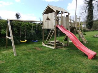 Custom made wooden play frame. Wooden garden climbing frame comes complete with different sizes of slide, and different types of swings in a wide range of colours. The garden climbing frame is designed for private use.